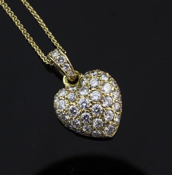 A Cartier 18ct gold and diamond encrusted heart shaped pendant, 0.75in inc. bale.